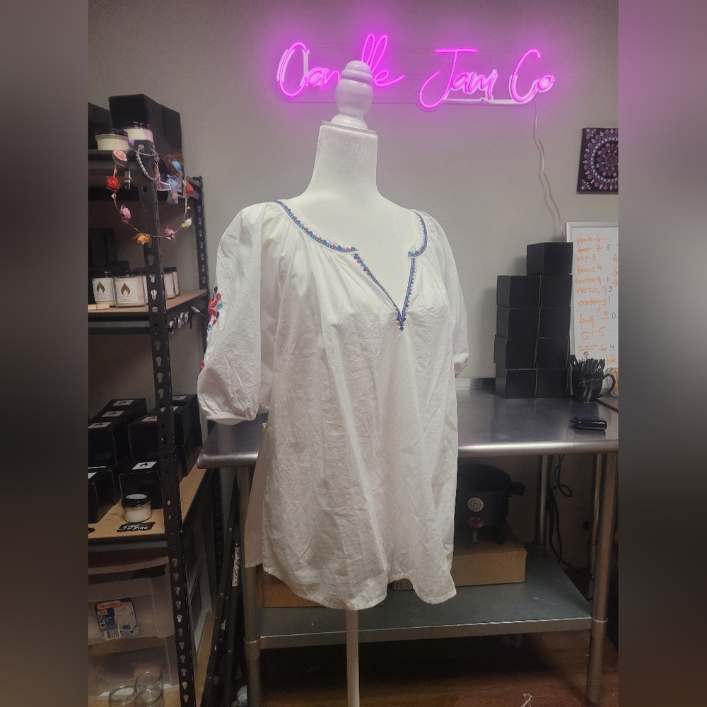 White ruffle shirt with flower detailing